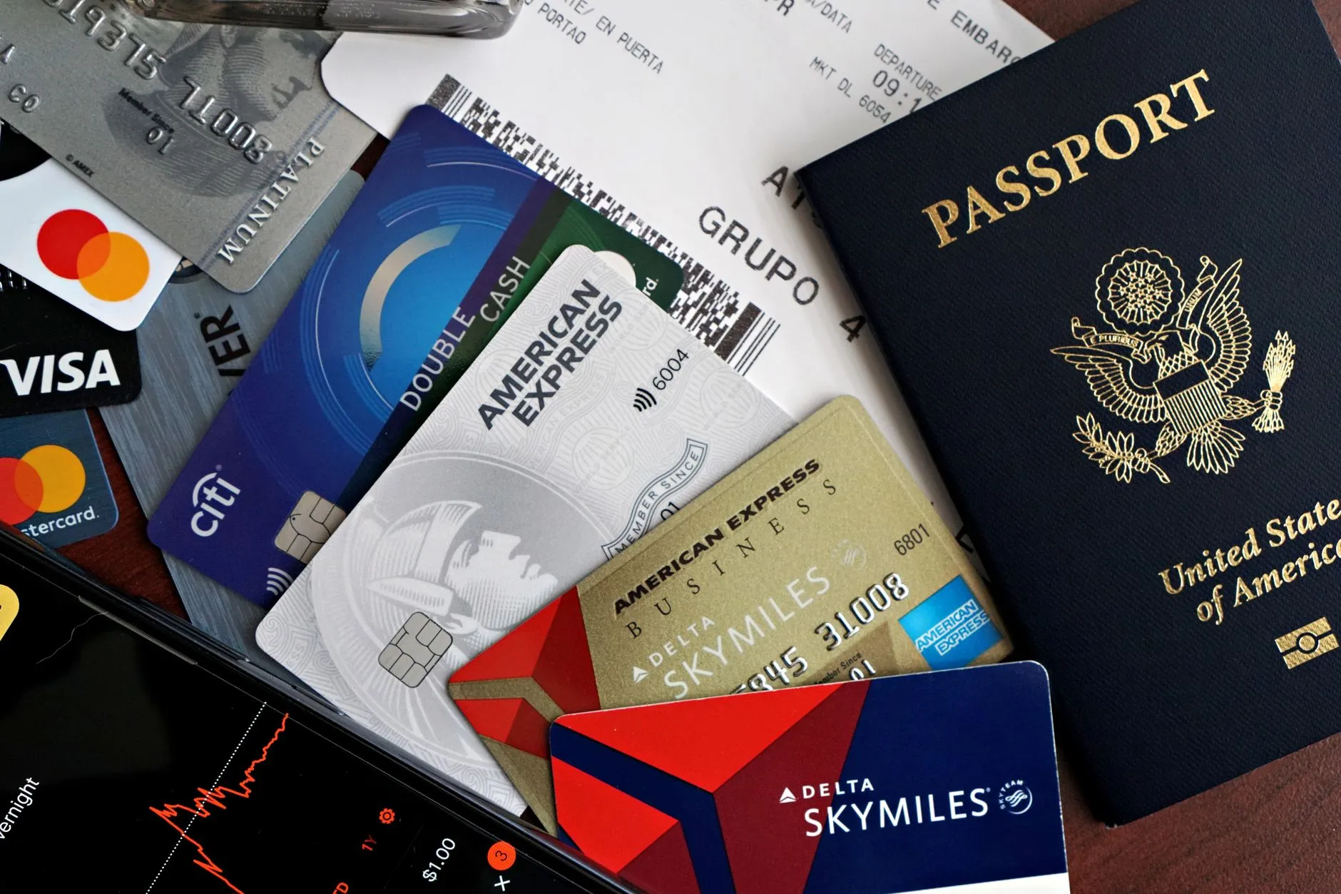 A collection of travel essentials including a passport, credit cards, and a boarding pass. Ideal for travel and finance concepts.