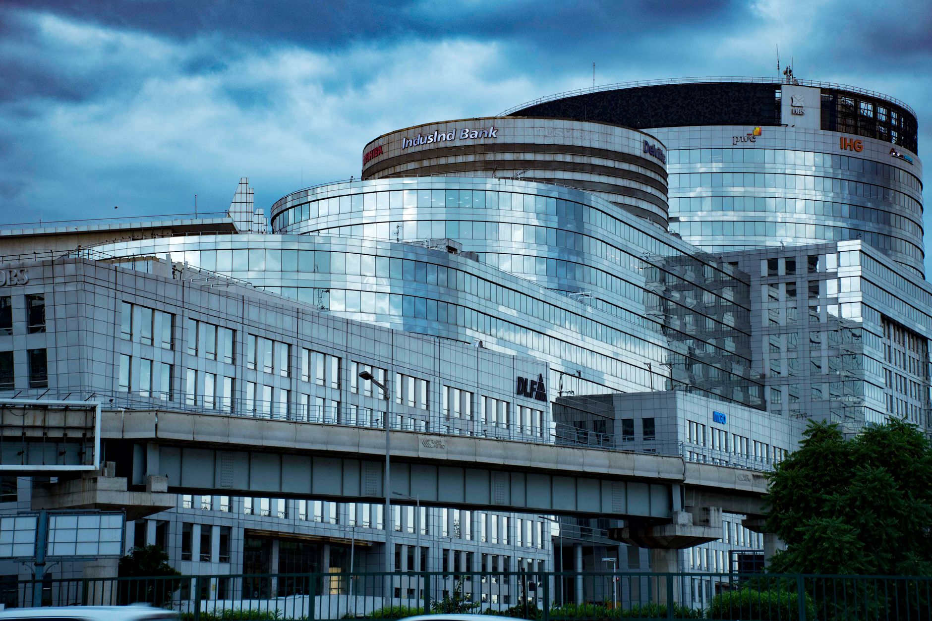 A sleek modern glass banking building in an urban city setting, showcasing reflective architecture.