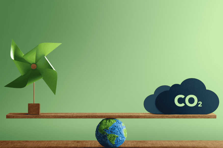 Balança com catavento, nuvem com CO2 e miniatura do planeta Terra