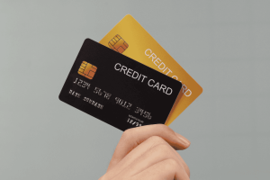 Hand holding two different credit cards, symbolizing the choice between multiple best credit card options.
