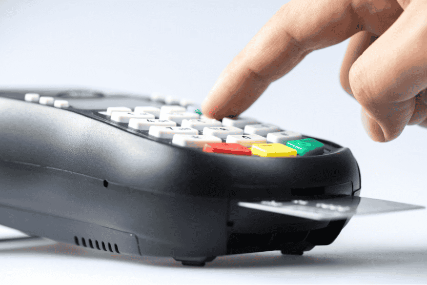 Person entering PIN on card terminal as a basic step to prevent credit card fraud