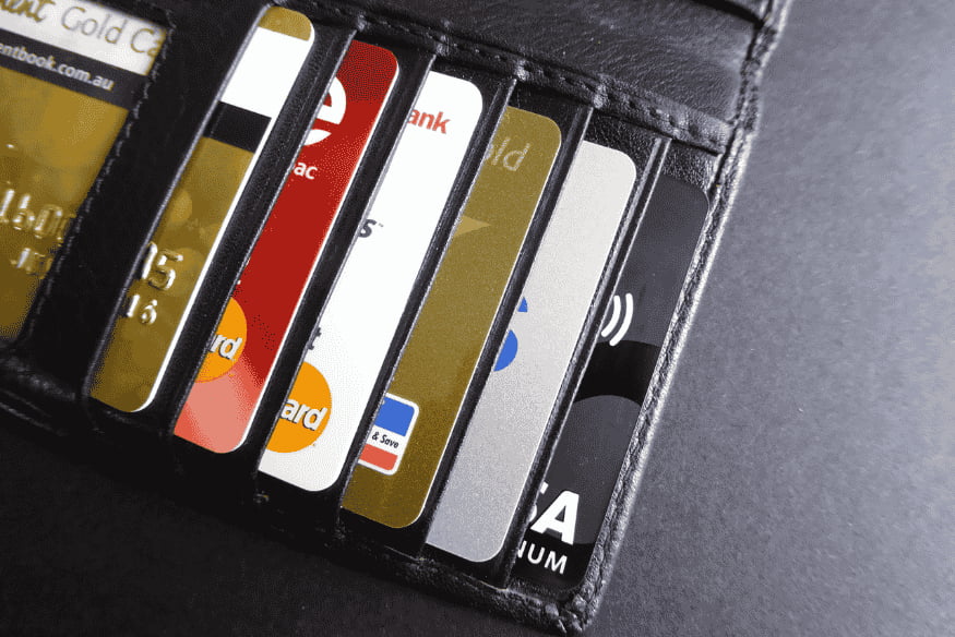 Wallet filled with multiple credit cards, illustrating the question of how many credit cards you should have