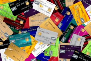 Many colorful credit cards scattered on a table representing different low-interest credit card options.