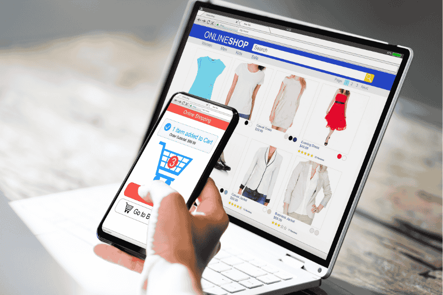 Online shopper using laptop and smartphone to maximize credit card rewards on every purchase in an online store.