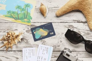 Travel credit card with boarding passes and vacation accessories ready for an international trip